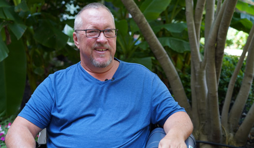 man in blue t shirt smiling at camera